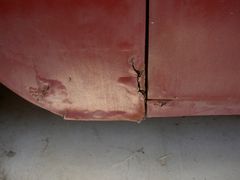 Driver side front lower fender rust.